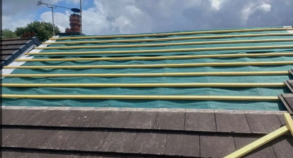 Roof replacement in progress with new breathable membrane and battens